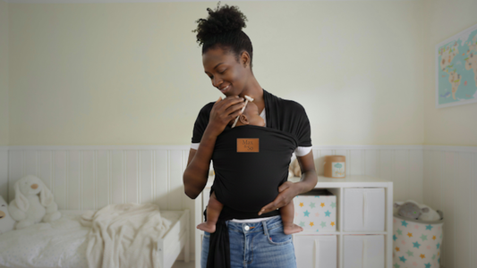 Mother safely wearing her newborn in a Max&So baby wrap carrier demonstrating ergonomic support and babywearing safety.